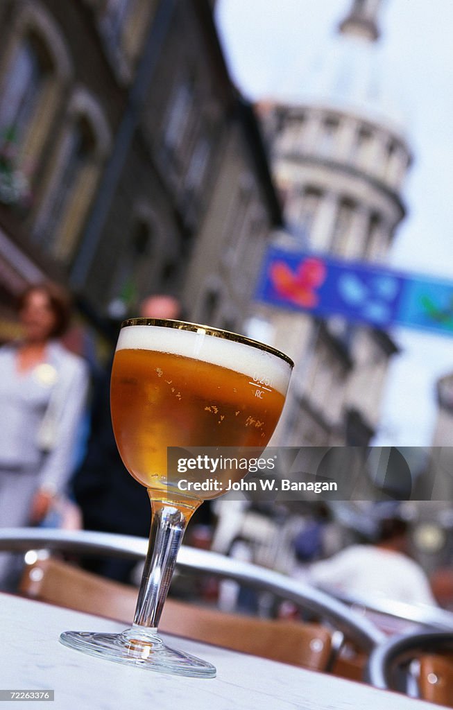 Glass of beer at cafe with cathedral in background, Boulogne-sur-Mer, France