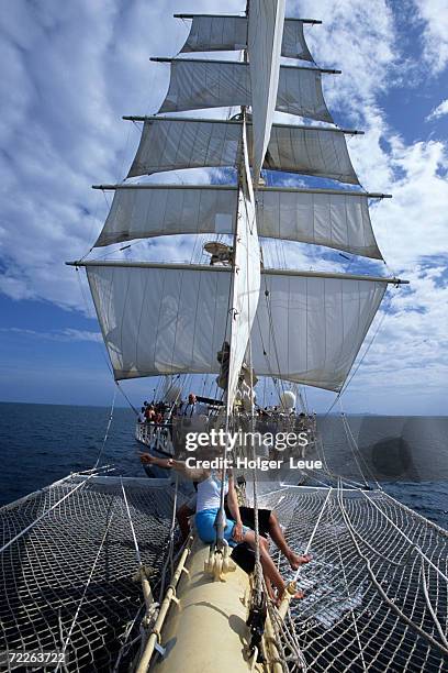 couple on star flyer bowsprit, andaman sea, thailand - star flyer stock pictures, royalty-free photos & images