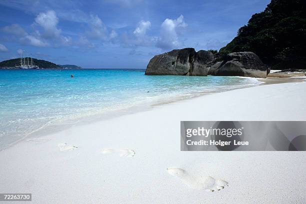 footprints in sand at ko similan beach, similan islands national marine park, thailand - similan islands stock pictures, royalty-free photos & images