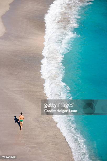 aerial view of a man strolling along shell beach, gustavia, st barts - french antilles stock pictures, royalty-free photos & images