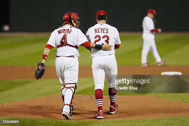 Yadier Molina and Anthony Reyes of the St. Louis Cardinals walk to the mound against the New York Mets during game four of the NLCS at Busch Stadium...