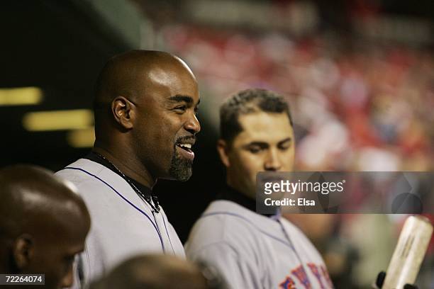 Carlos Delgado of the New York Mets smiles in the dugout against the St. Louis Cardinals during game four of the NLCS at Busch Stadium on October 15,...