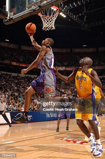 Leandro Barbosa of the Phoenix Suns drives to the basket for a layup past Aaron McKie of the Los Angeles Lakers during a preseason game at Thomas and...