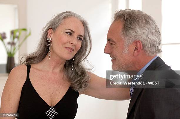 mature couple looking at each other, smiling - female décolletage stock pictures, royalty-free photos & images