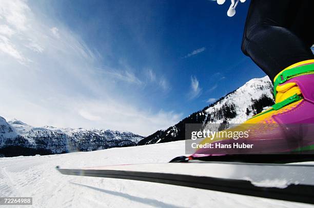 woman cross-country skiing, low section - ski closeup stock-fotos und bilder