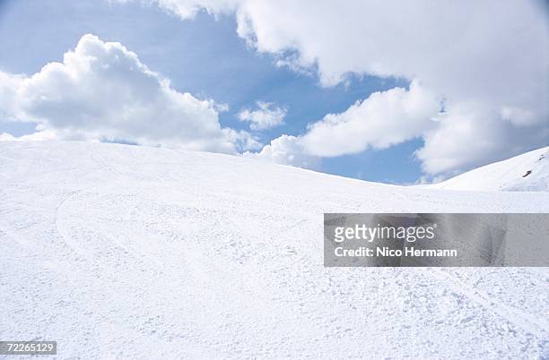 snowy hills under cloudy sky - hill stock-fotos und bilder