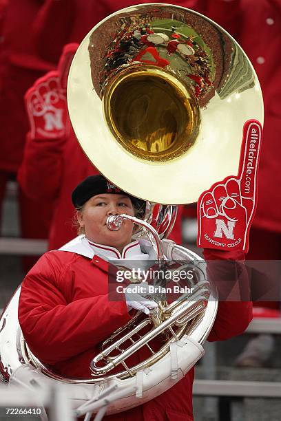 Member of the Nebraska Cornhuskers band holds up a foam finger as she plays her instrument during the game between the Nebraska Cornhuskers and the...