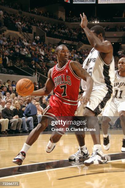 Ben Gordon of the Chicago Bulls drives around Jackie Butler of the San Antonio Spurs during the preseason game on October 19, 2006 at the AT&T Center...