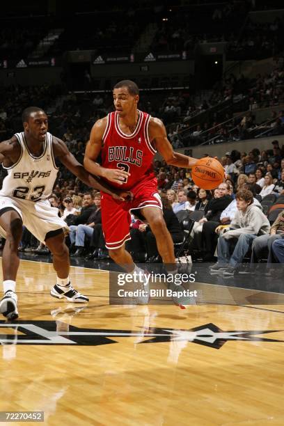 Thabo Sefolosha of the Chicago Bulls is defended by Olu Famutimi of the San Antonio Spurs during a preseason NBA game at the AT&T Center on October...