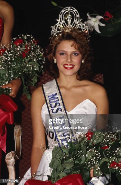 Miss Norway, Mona Grudt, poses with crown and flower bouquet after she was crowned at the televised 1990 Miss Universe Pageant held at the Century...