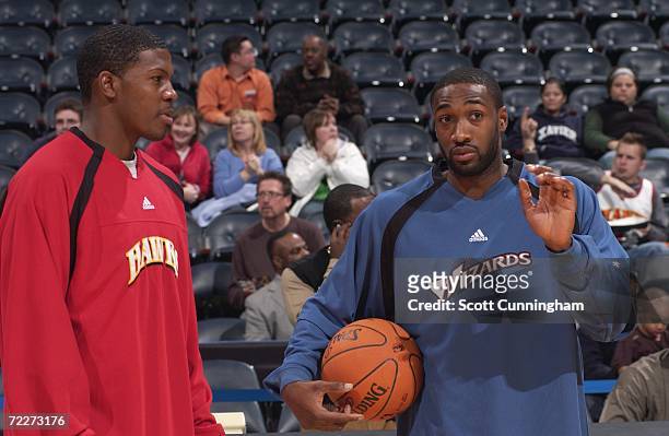 Joe Johnson of the Atlanta Hawks talks with Gilbert Arenas of the Washington Wizards prior to a preseason game at Philips Arena on October 23, 2006...
