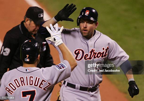 Sean Casey of the Detroit Tigers celebrates with Ivan Rodriguez after Casey hit a solo home run in the top of the second inning against Jeff Suppan...