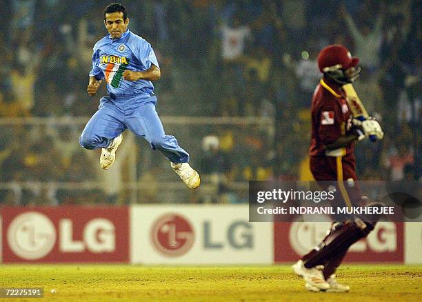 Indian cricketer Irfan Pathan jumps in the air to celebrate the wicket of West Indian cricketer Brian Lara during their ICC Champions Trophy 2006...