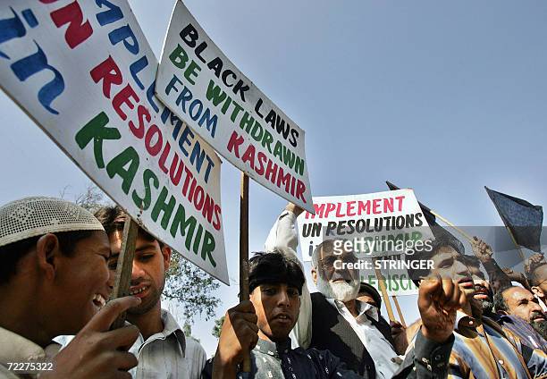 Activists of the All Parties Hurriyat Freedom Conference carry placards and march during a protest rally against aggression in held Kashmir, in front...