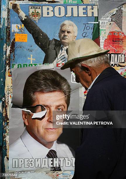 An elderly Bulgarian passes by pre-election campaign posters of ultra-nationalist candidate Volen Siderov and incumbent president Georgy Parvanov ,...