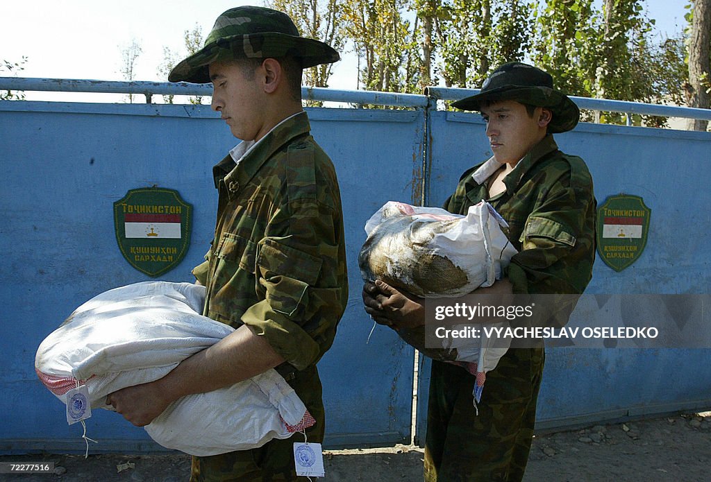 Tajik frontier guard soldiers carry bags