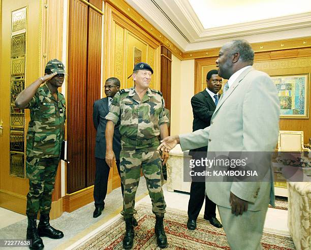 Chief of the French military mission Licorne, General Antoine Lecerf and General Mangou Philippes , head of the Ivory Coast army are greeted by...
