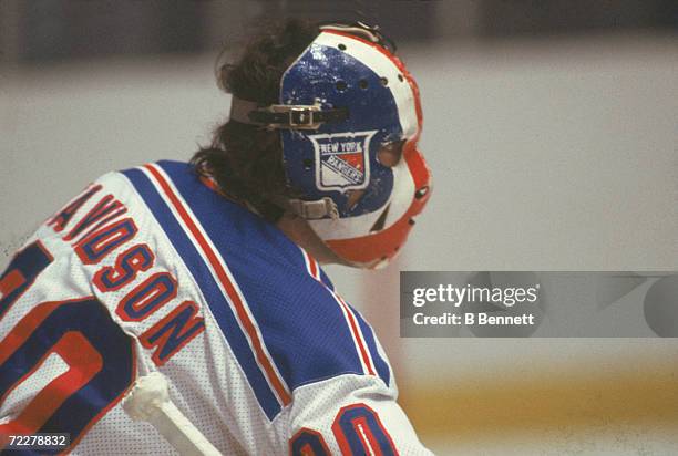 Canadian hockey player John Davidson, goalkeeper for the New York Rangers, on the ice during a game, late 1970s or early 1980s.