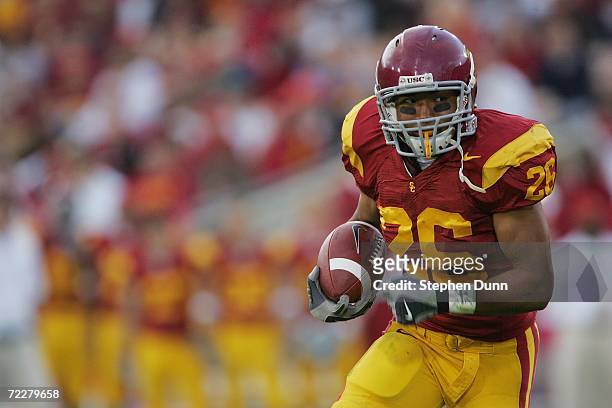 Running back Emmanuel Moody of the USC Trojans carries the ball against the Arizona State Sun Devils at the Los Angeles Memorial Coliseum on October...