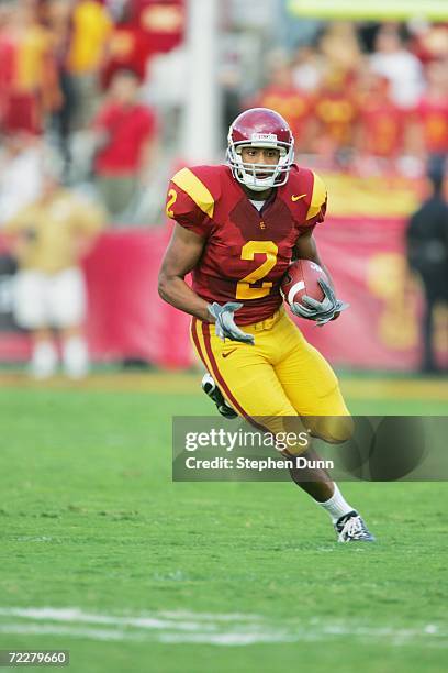 Wide receiver Steve Smith of the USC Trojans carries the ball against the Arizona State Sun Devils at the Los Angeles Memorial Coliseum on October...