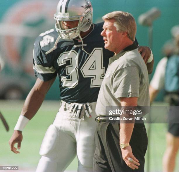 Fullback Herschel Walker of the Dallas Cowboys greets coach Jimmy Johnson of the Miami Dolphins prior to the Cowboys v Dolphins game at Pro Player...