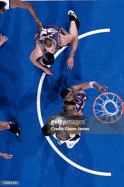 Forward Michael Finley of the Dallas Mavericks shoots the ball as guard Joe Johnson of the Phoenix Suns plays defense during the NBA game at the...