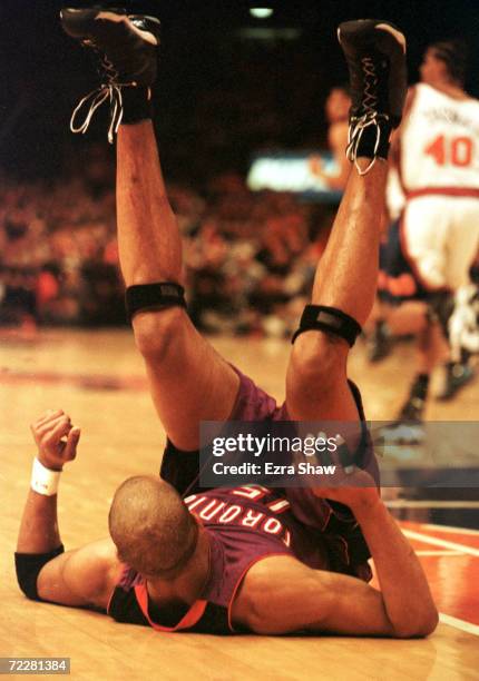 Vince Carter of the Toronto Raptors upside down after being tripped during their game against the New York Knicks at Madison Square Garden in New...