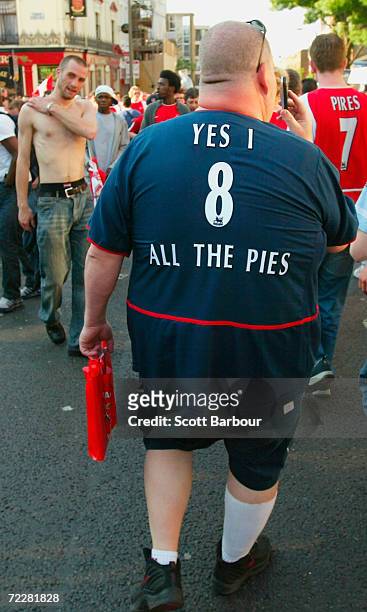 An Arsenal fan makes his way home after the FA Barclaycard Premiership match between Arsenal and Leicester City at Highbury on May 15, 2004 in...