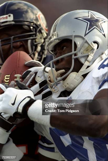 Michael Irvin of the Dallas Cowboys tries to keep the ball during a game against the Chicago Bears at Soldier Field in Chicago, Illinois. The Bears...