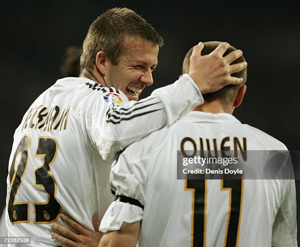David Beckham of Real Madrid congratulates teammate Michael Owen after he scored a goal against Zaragoza during the Primera Liga soccer match between...