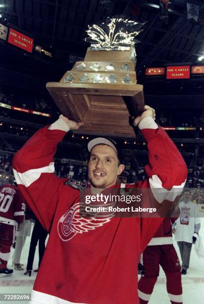 Steve Yzerman of the Detroit Red Wings hoists the Con Smythe trophy over his head following game four of the Stanley Cup Finals against the...