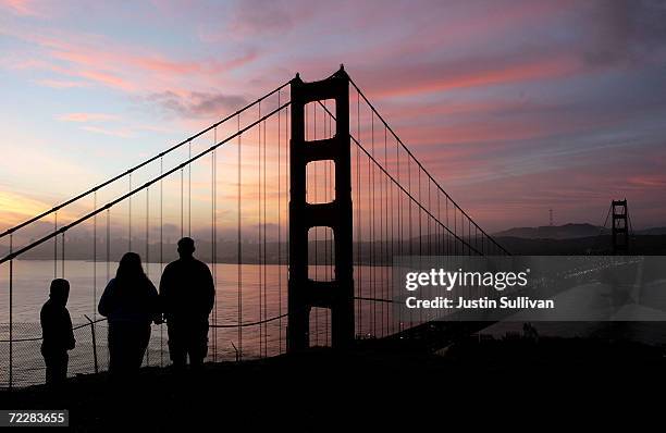 People look at the Golden Gate Bridge as the sun rises January 27, 2005 in San Francisco. A controversial film made by moviemaker Eric Steel...