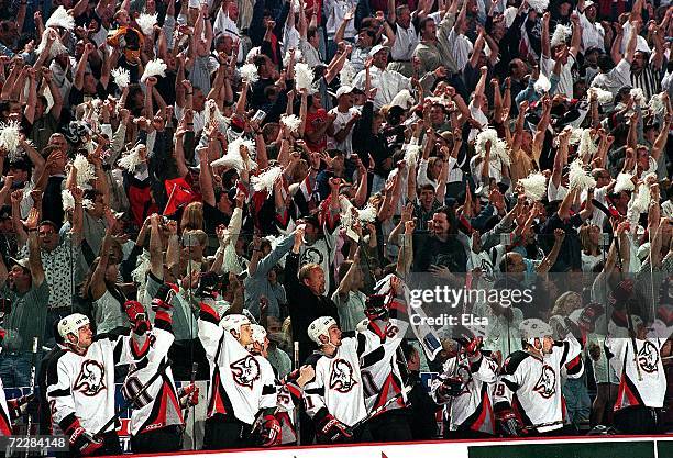 The Buffalo Sabres bench celebrates with the crowd after the goal against the Toronto Maple Leafs during the Stanley Cup playoffs at the Marine...