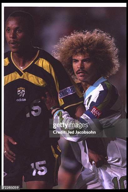 Carlos Valderrama of the Tampa Bay Mutiny and Doctor Khumalo of the Columbus Crew look on during a game at Ohio Stadium in Columbus, Ohio. The Mutiny...