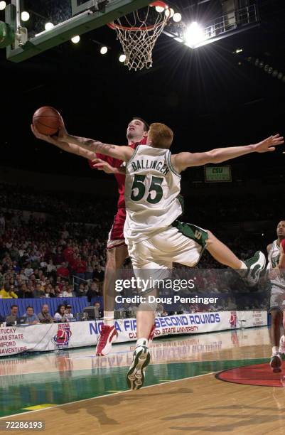 Alex Jensen of the University of Utah goes to the basket and is fouled by Adam Ballinger of Michigan State University in round two of the Midwest...