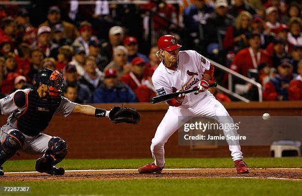 Jeff Weaver of the St. Louis Cardinals bunts for a fielders' chcoice to pitcher Justin Verlander of the Detroit Tigers in the bottom of the fourth...