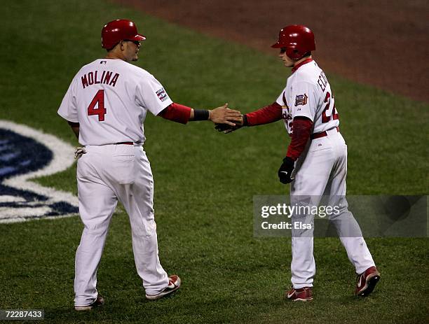 David Eckstein and Yadier Molina of the St. Louis Cardinals after Molina scored on a throwing error by Justin Verlander of the Detroit Tigers, on a...