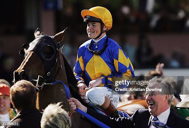 Craig Williams celebrates with the connections after riding Fields Of Omagh to victory in the 2006 Tattersall's W.S. Cox Plate during the Cox Plate...
