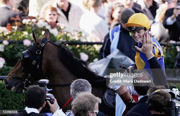 Craig Williams gets a high five from Fields Of Omagh trainer David Hayes after riding to victory in the Tattersall's W. S. Cox Plate during the Cox...