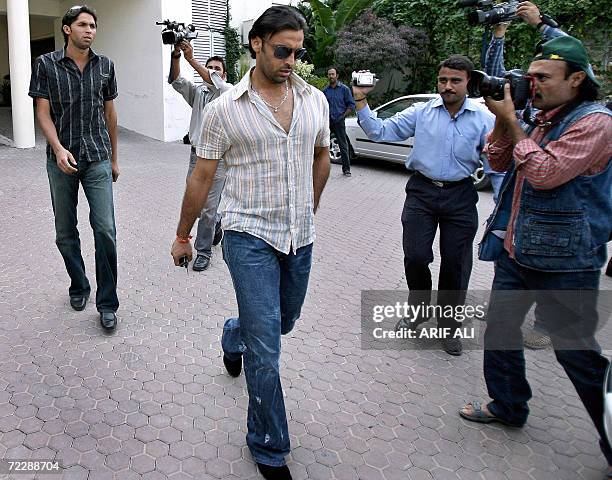 Pakistani banned pacer Shoaib Akhtar and Mohammad Asif leave the Gaddafi Cricket stadium after a hearing on doping charges in Lahore, 28 October...