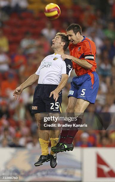 Damian Mori of the Mariners and Joshua McCloughlan of the Roar jump in the air to compete for the ball during the round ten Hyundai A-League match...