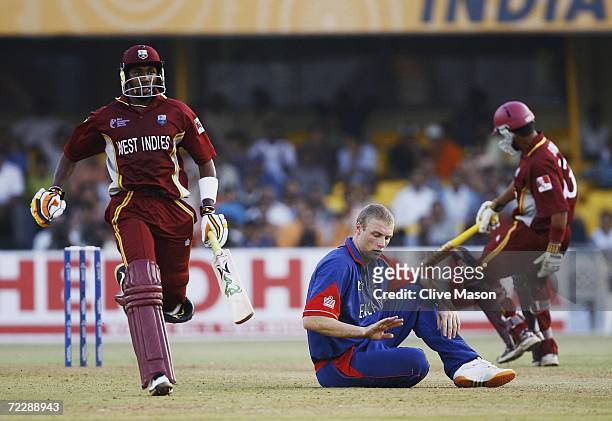 Dwayne Bravo of West Indies continues to score as Andrew Flintoff of England can only look on, during the ICC Champions Trophy match between England...