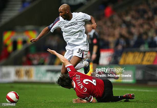 Gary Neville of Manchester United slides in to challenge Nicolas Anelka of Bolton Wanderers during the Barclays Premiership match between Bolton...