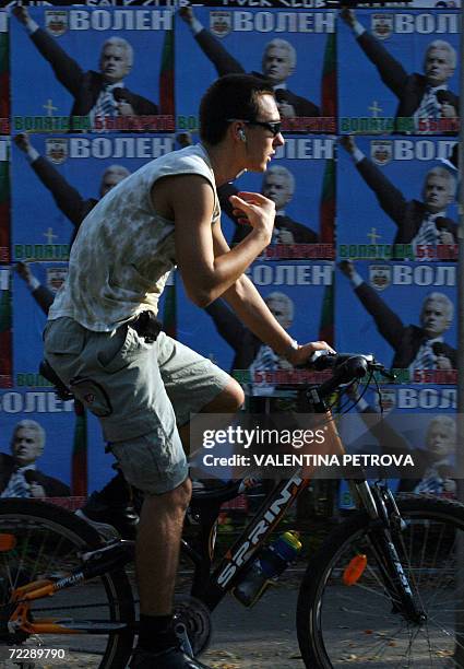 Cyclist passes posters of the ultra-nationalist candidate Volen Siderov, in Sofia, 28 October 2006.. Despite garnering the most votes in the...