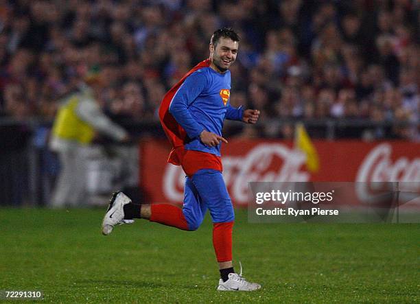 Fan dressed as Superman runs on the pitch during the International Rules First Test between Ireland and Australia at Pearse Stadium on October 26,...