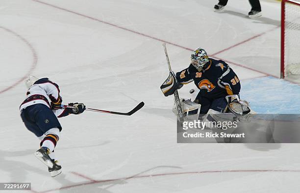 Vyacheslav Kozlov of the Atlanta Thrashers scores the game winning goal in a shootout against Ryan Miller of the Buffalo Sabres on October 28, 2006...