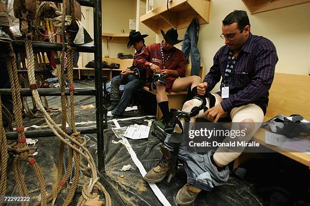 Brothers Allan Moraes, Adriano Moraes, and Andre Moraes of Brazil prepare themselves for competition in the men's changing room during the...