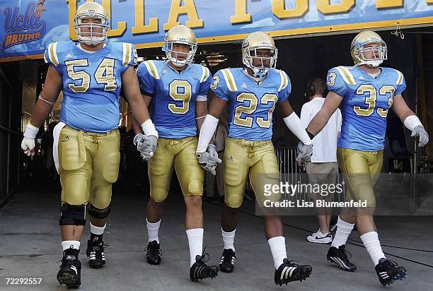 Kyle Bosworth, Marcus Everett, Trey Brown and Christian Taylor of the UCLA Bruins enter the field before taking on the Washington State Cougars on...