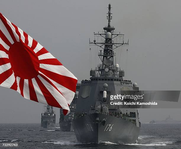 Ships sail in formation behind the flag of the Japanese Maritime Self-Defense Force during a naval fleet review on October 29, 2006 off Sagami Bay,...