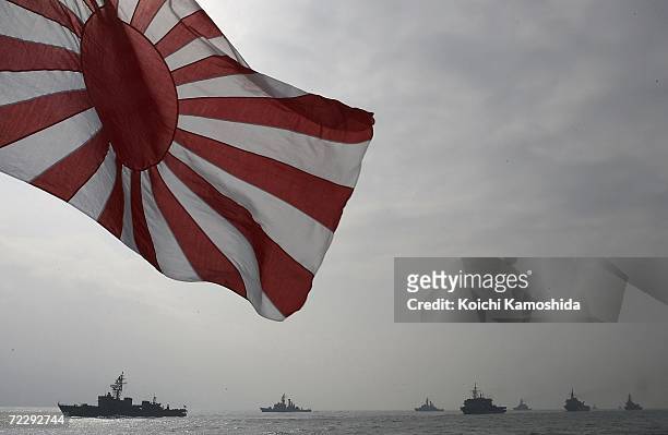 The flag of the Japanese Maritime Self-Defense Force flies during a naval fleet review on October 29, 2006 off Sagami Bay, Japan. Prime Minister...